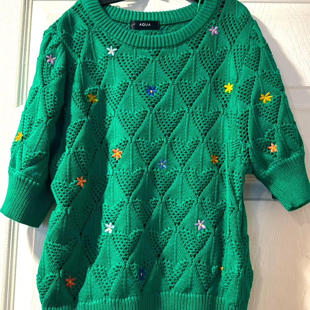 A chic green multi-color flower sweater with a sleek design.